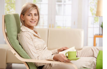 A woman relaxing and enjoying a hot drink.